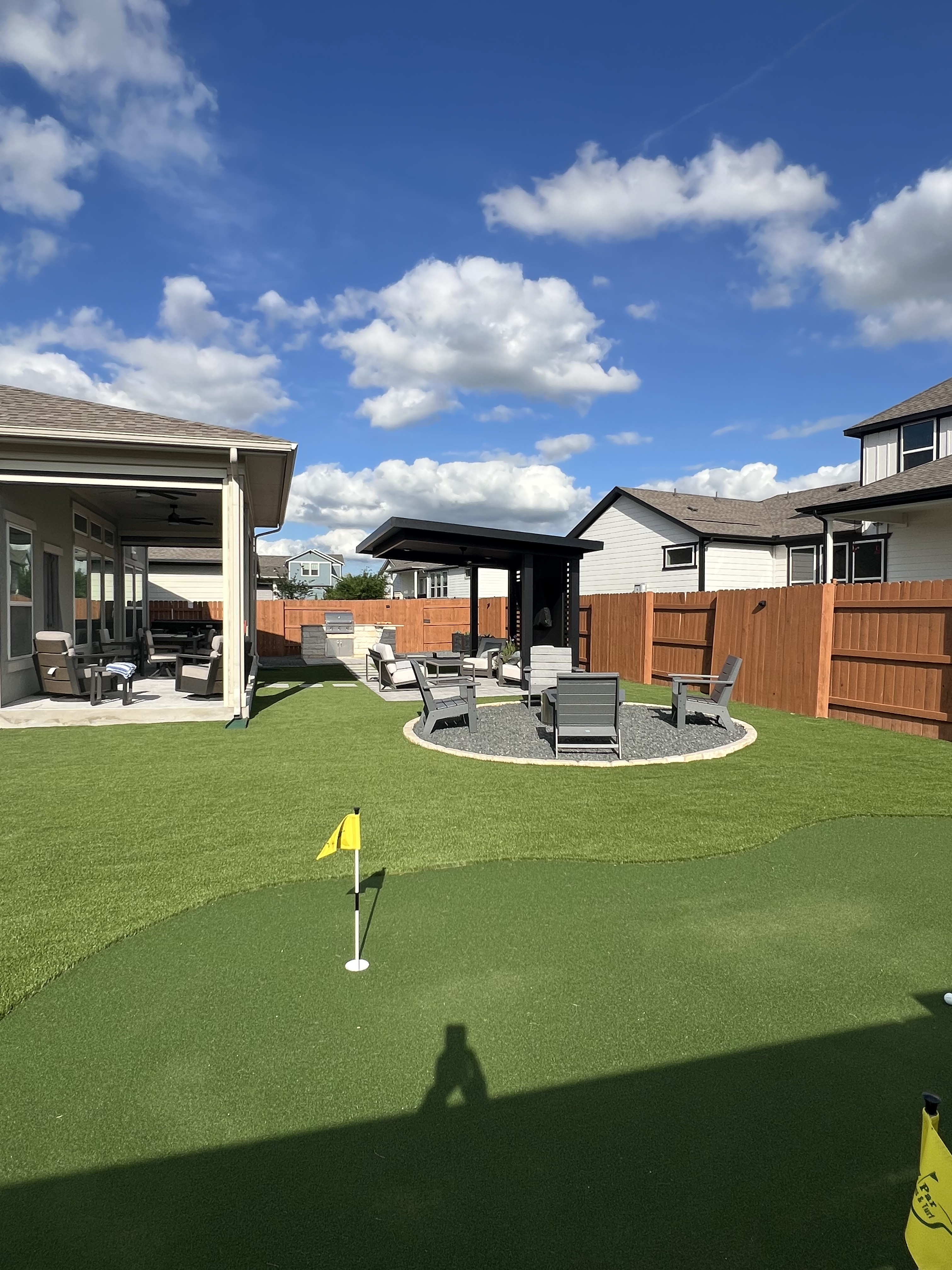EZ Par backyard landscape with artificial turf, custom putting green and outdoor living area